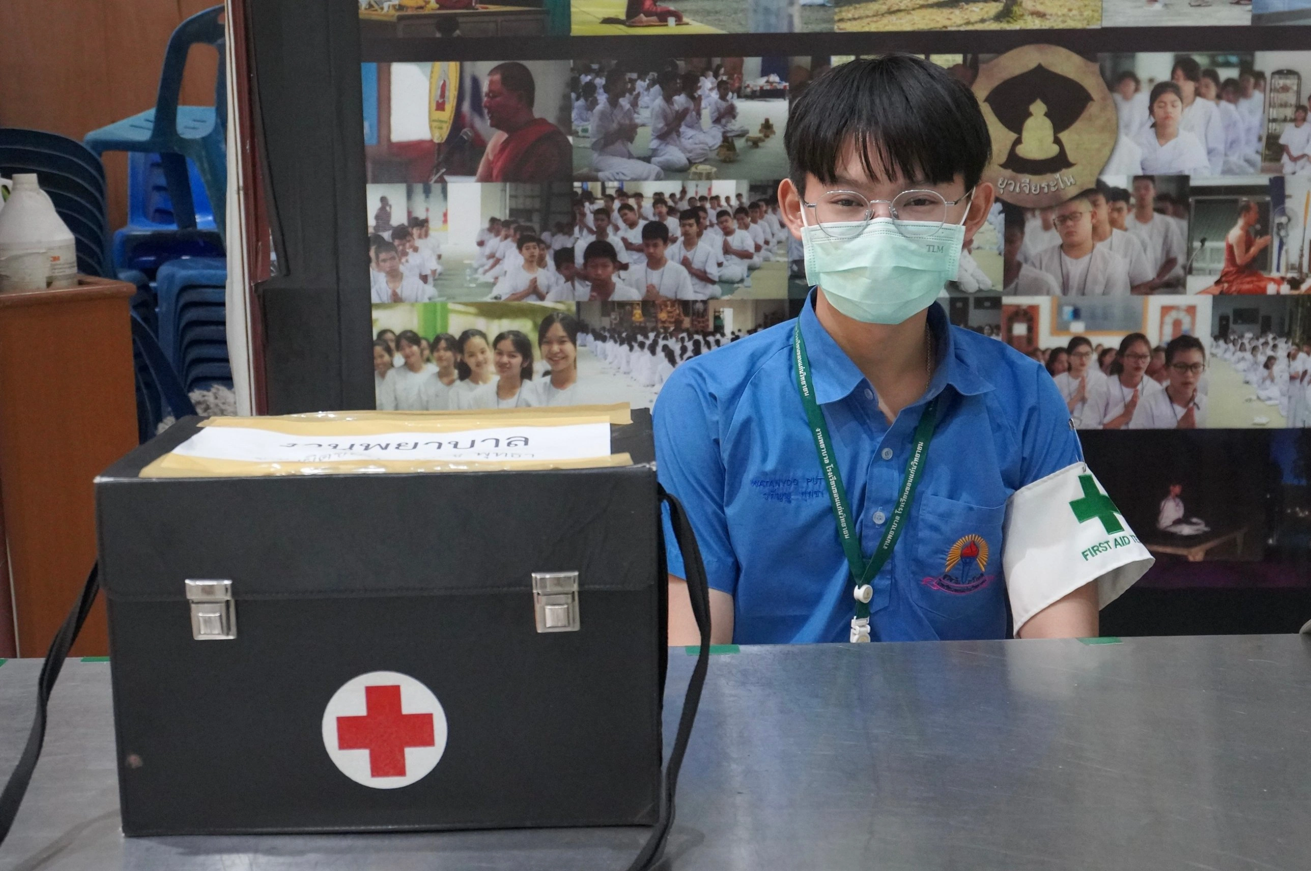 Watanyoo Putta at a school first aid station with a first aid kit